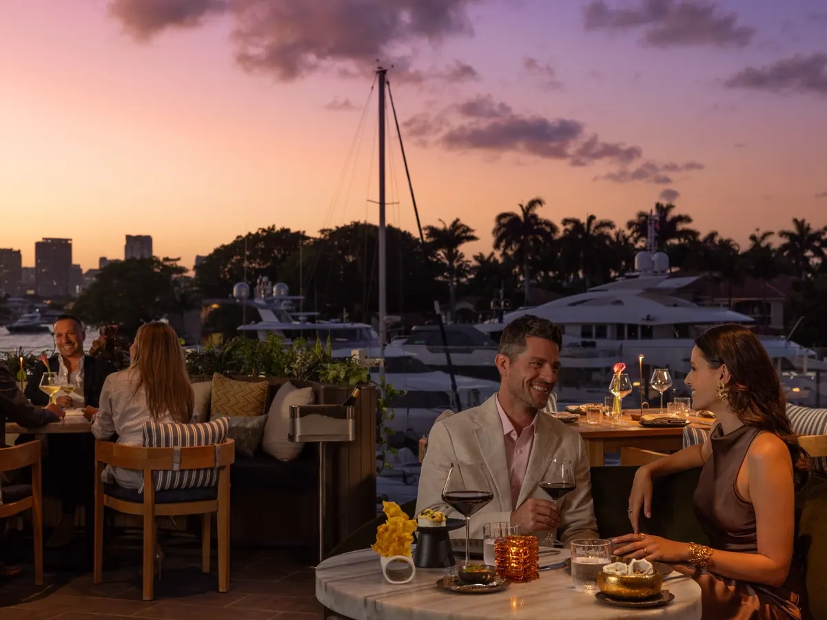 Couple dining on the Calusso terrace at sunset