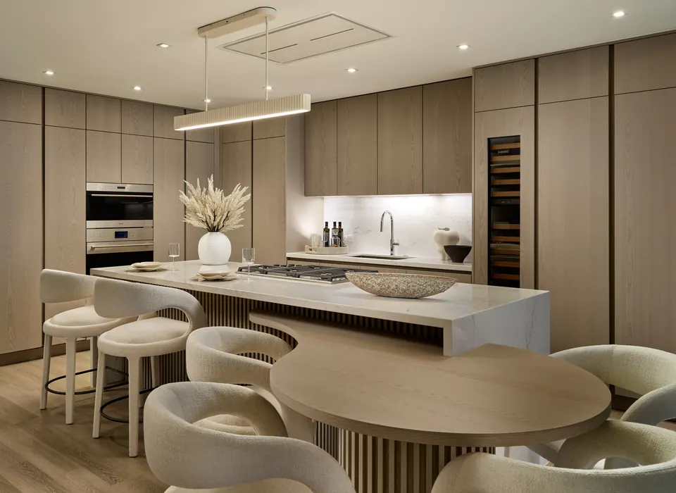 Indigo residence kitchen with sculpted island and dining table