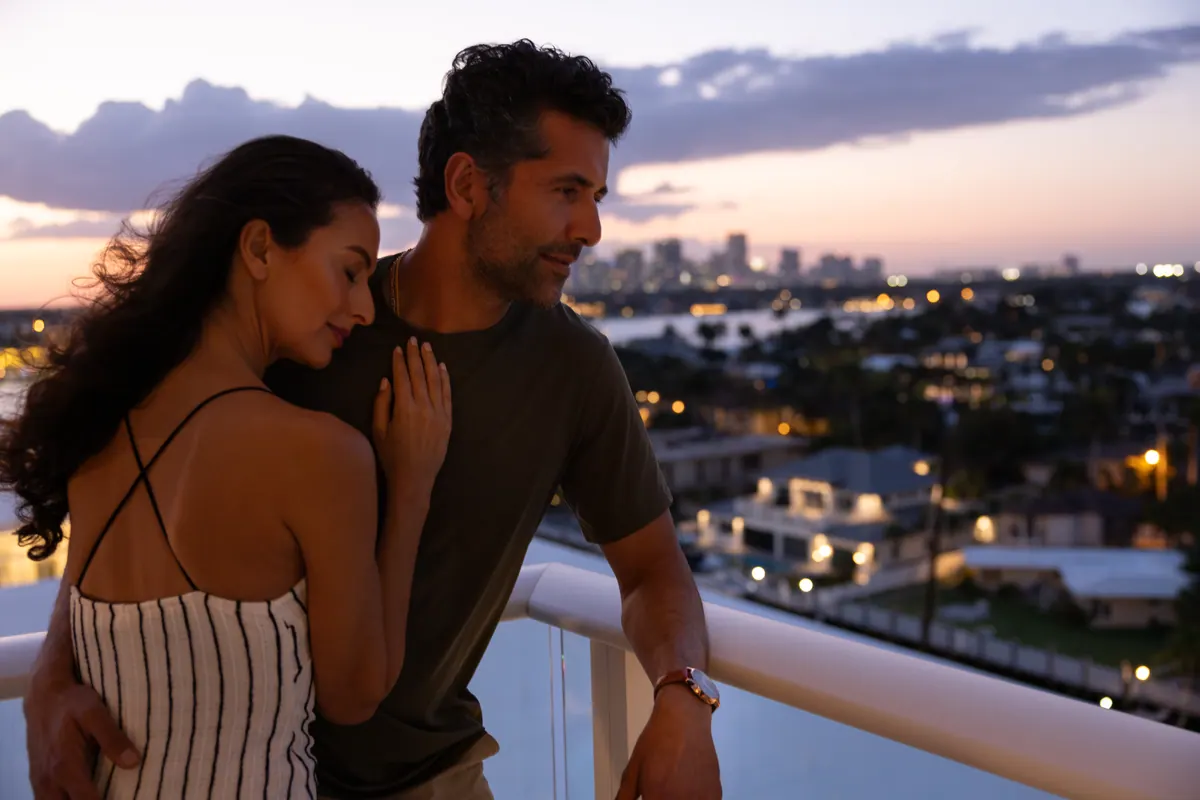 Couple on a residence balcony overlooking Fort Lauderdale at dusk