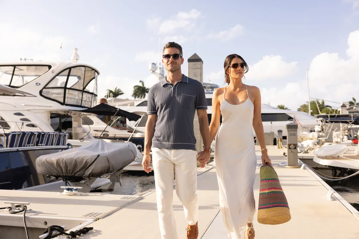 Couple walking along the Pier Sixty-Six marina docks